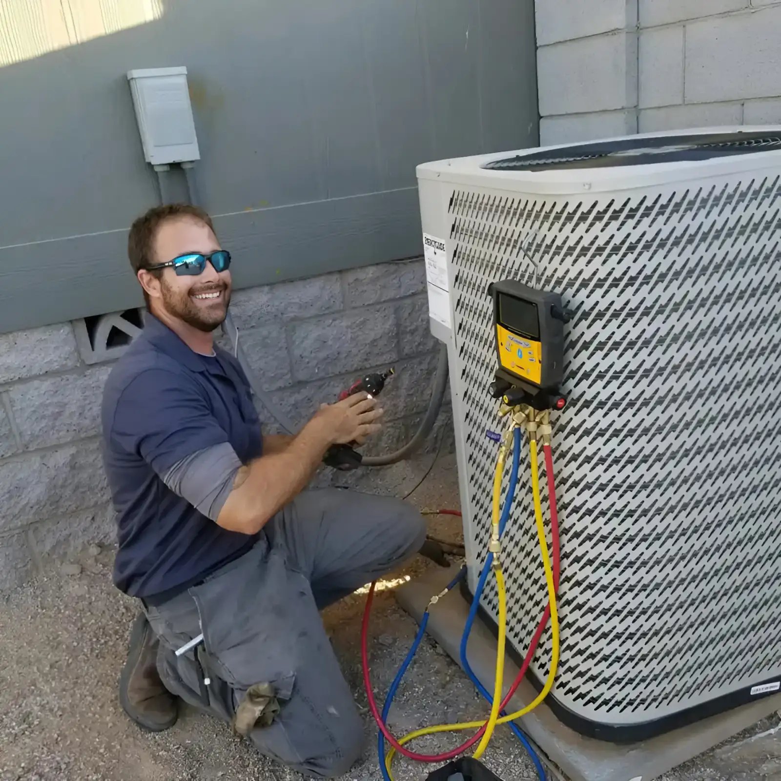 HVAC technician servicing an outdoor air conditioning unit. 